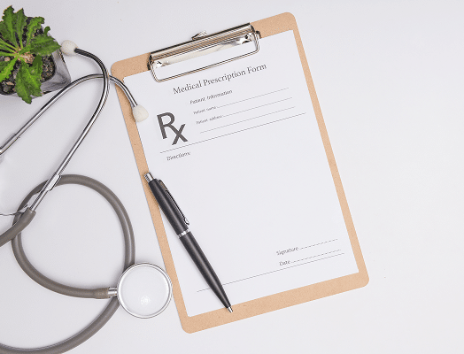 Clipboard with a prescription form, stethoscope, and pen
